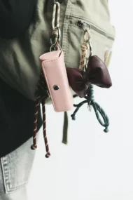 Close-up of a bow charm accessory attached to a bag