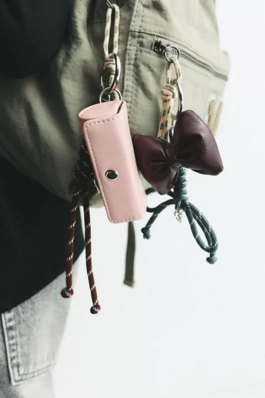 Close-up of a bow charm accessory attached to a bag